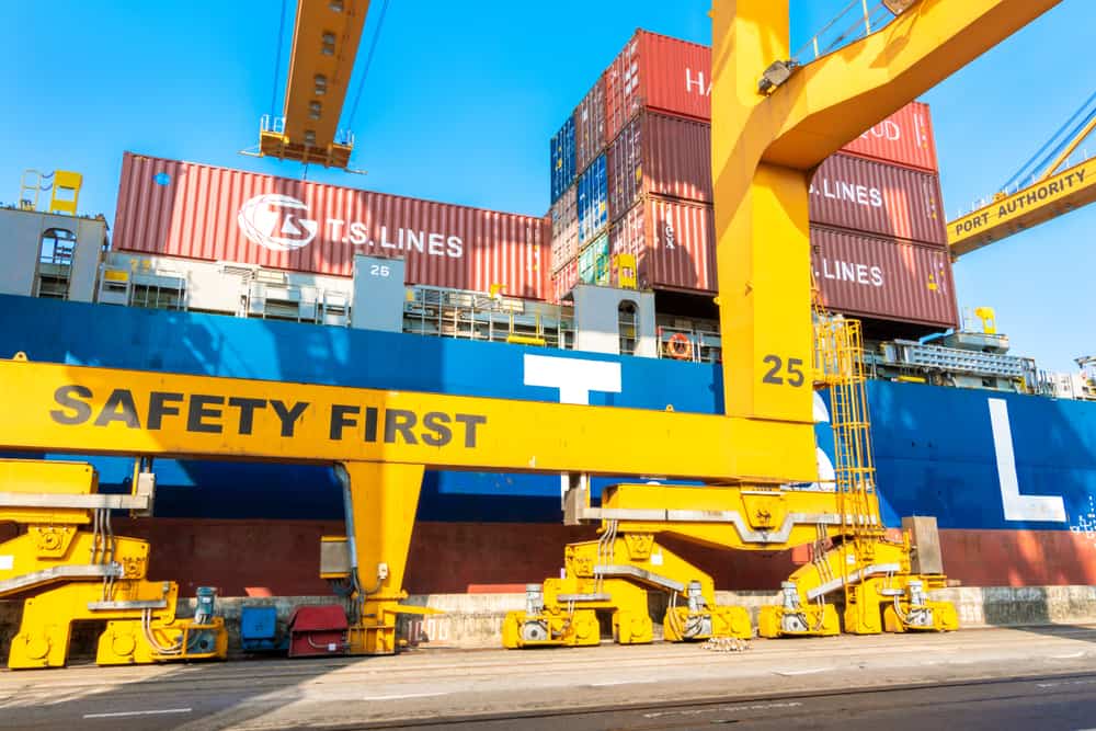 A container ship operated by TS Lines docked at the port of Bangkok, Thailand.